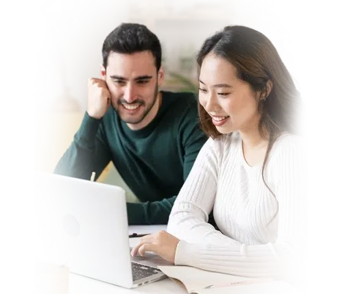 two people smiling at a laptop screen in a cozy room(card)