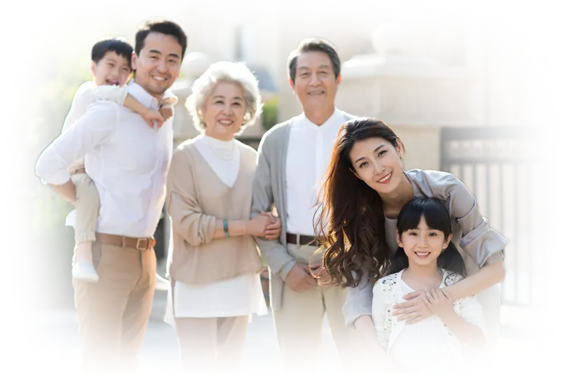 Multigenerational family smiling together outdoors in front of a home